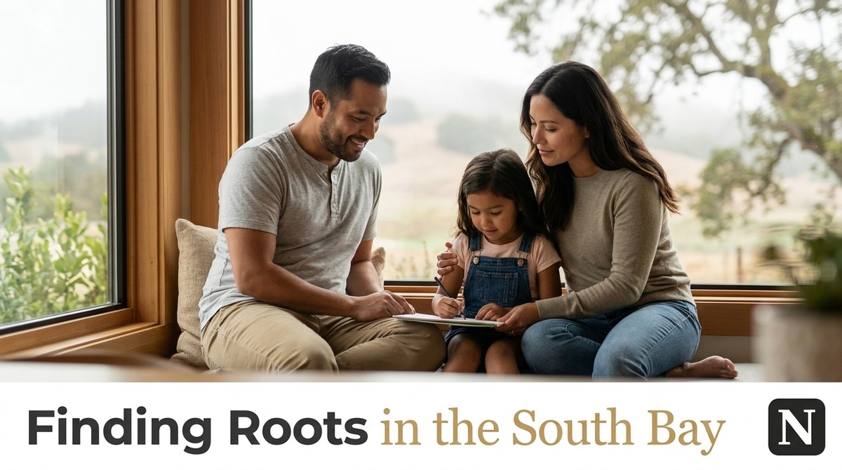A family of three, parents and young daughter, drawing together by a large window with a view of hills.